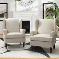 Fauteuils en tissu traditionnels avec pieds usinés, deux chaises par ensemble.